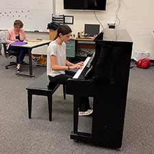 4-H participant playing the piano