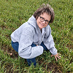 Sandra Leaning Down in Wheat Field Photo